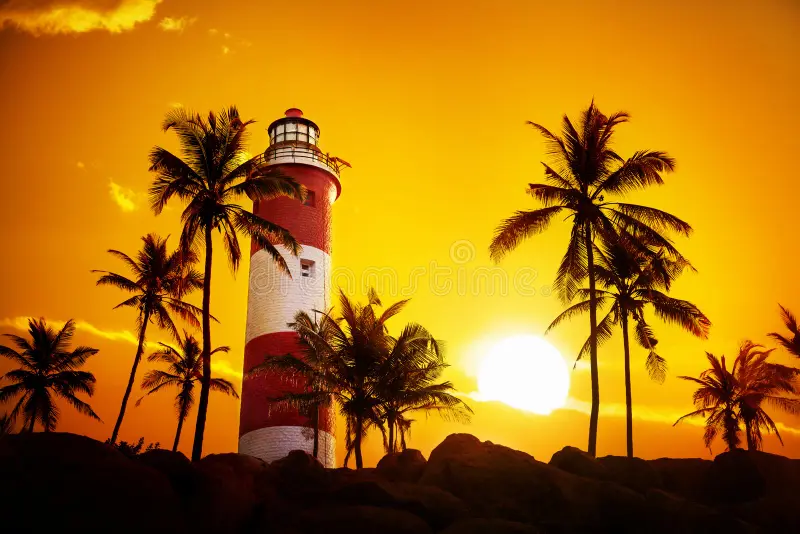 lighthouse sunset around palm trees orange sky kovalam kerala india 36820806